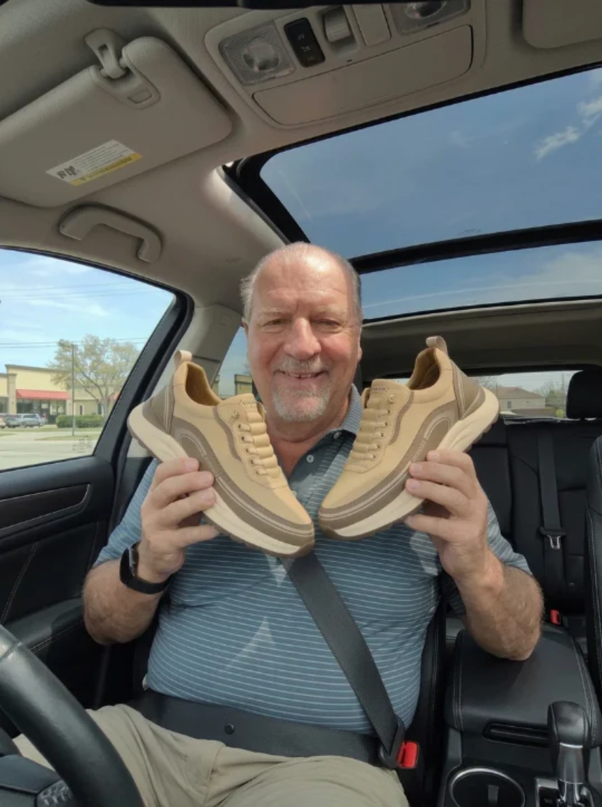 Customer Michael holding a pair of shoes