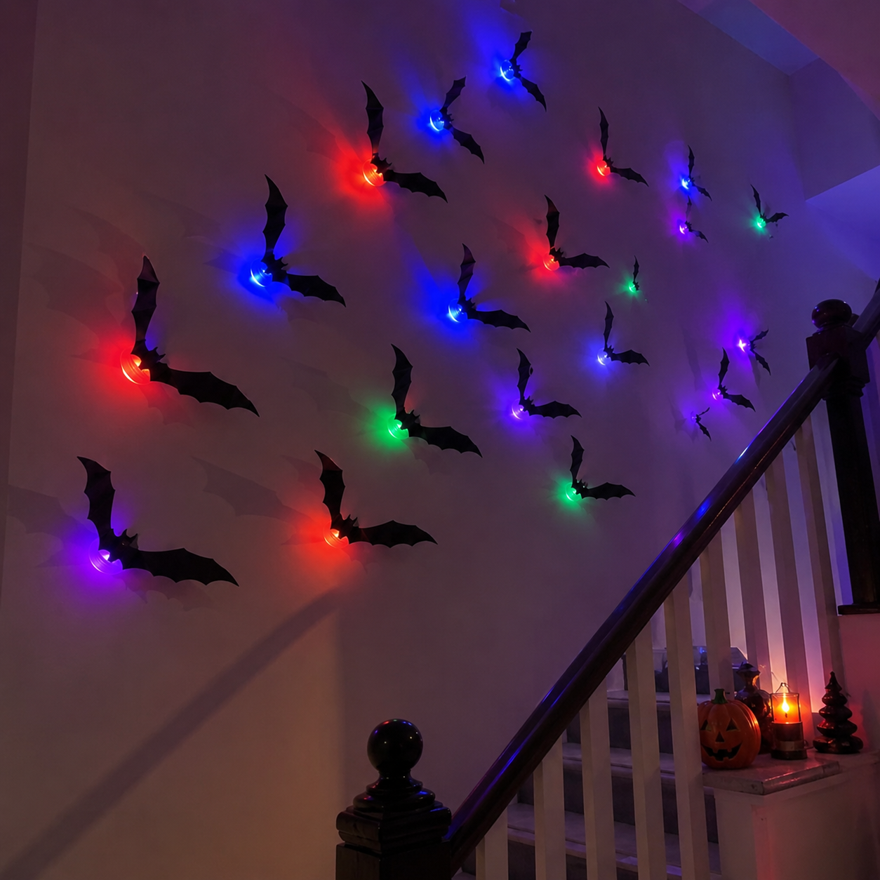 Colorful illuminated bat decorations arranged along a staircase